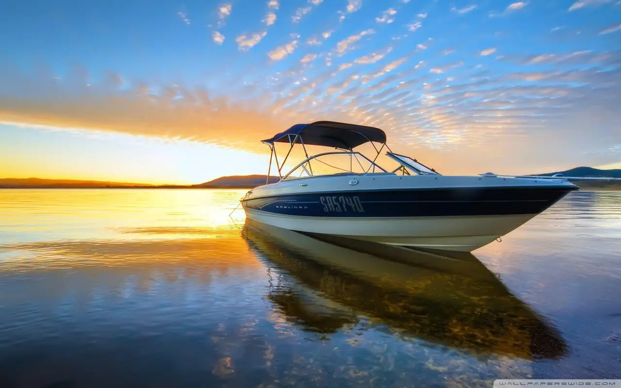 Performance boat on calm water at sunset