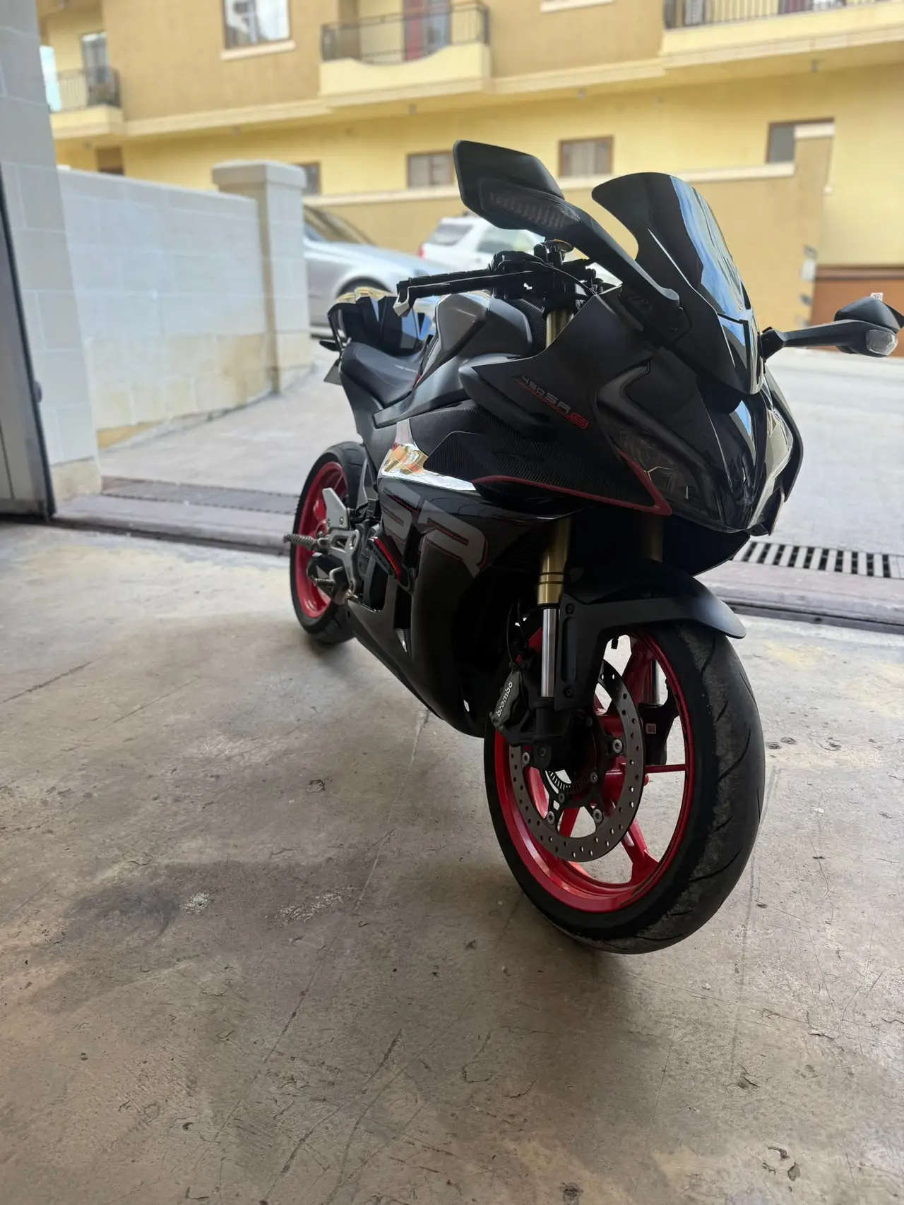 Black motorcycle with red wheels ready to ride
