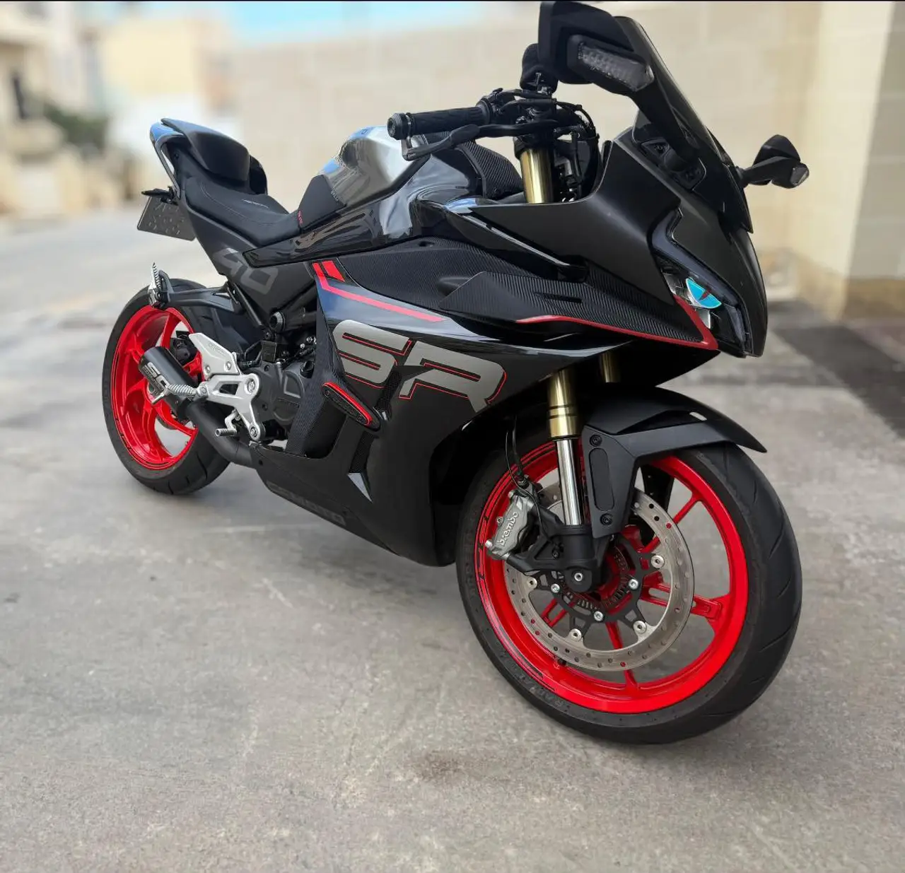 Black sport motorcycle with blood-red wheels